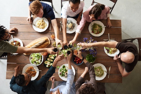 a group of people eating together at a table